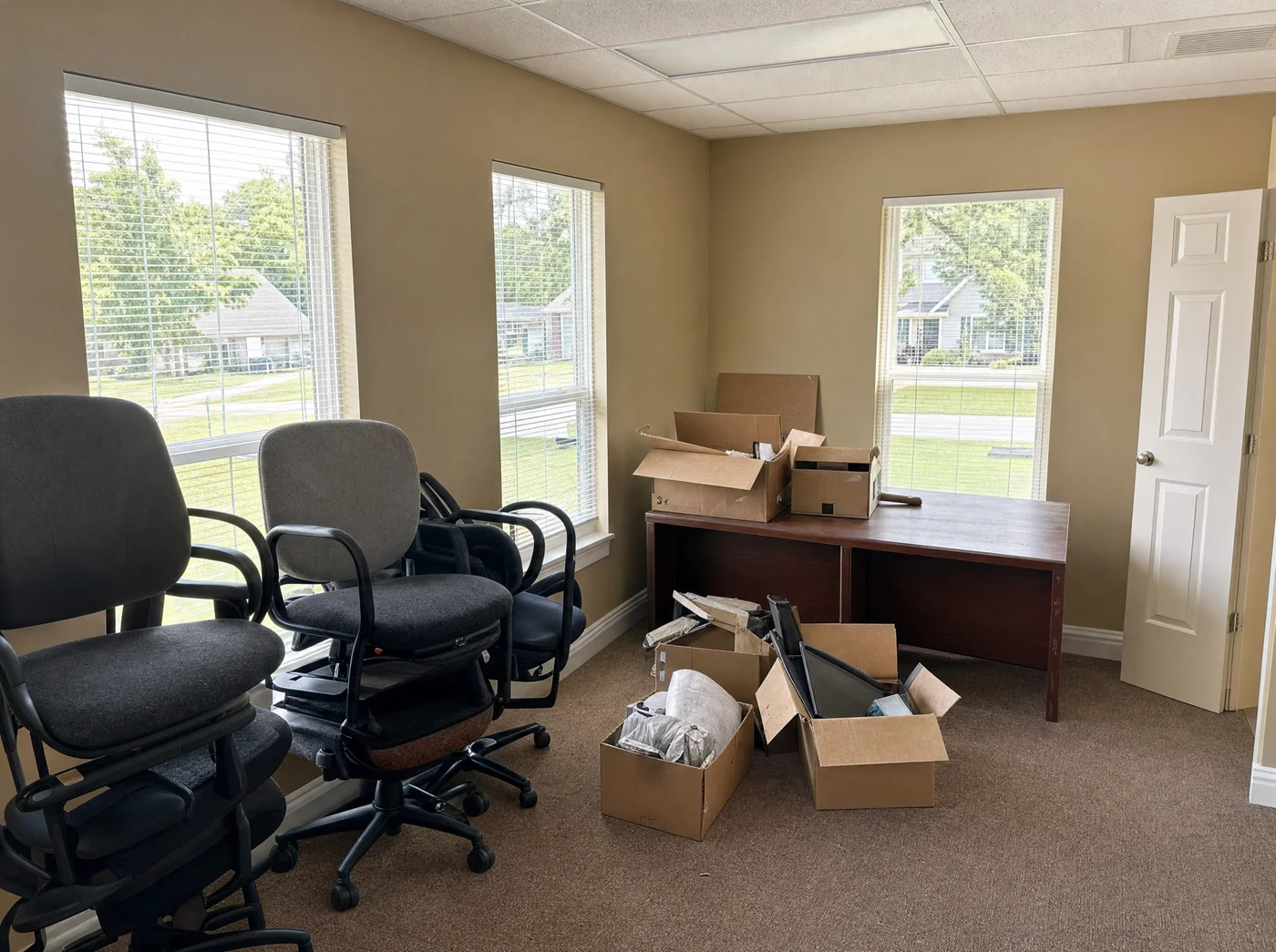 Office furniture and equipment set out for a commercial cleanout