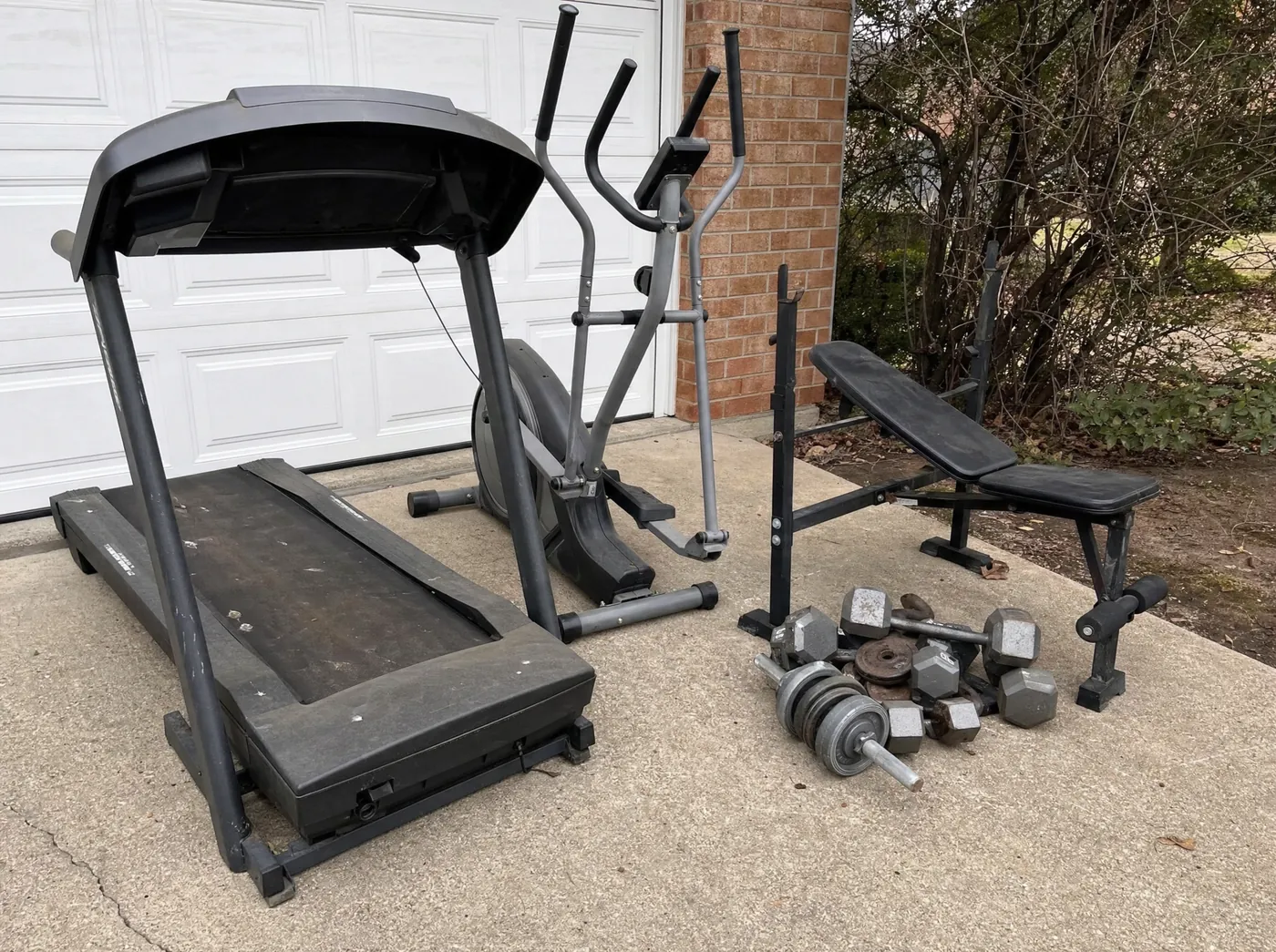 Old treadmill and home gym equipment set out for removal