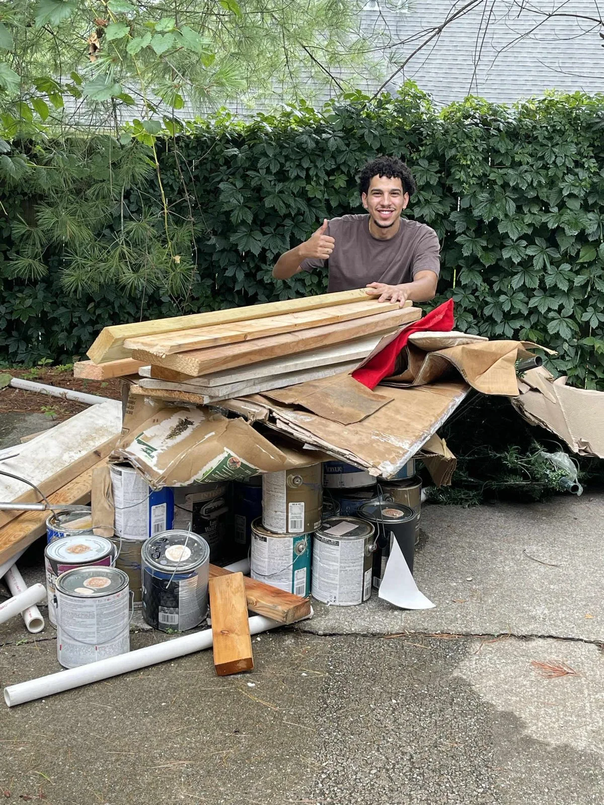 Buddies owner-operator with a pile of scrap lumber and remodel debris ready to haul