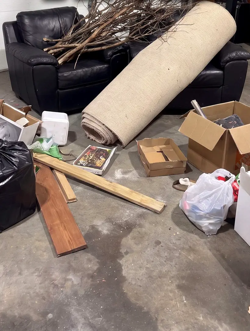 Cluttered garage full of furniture and boxes ready for a cleanout