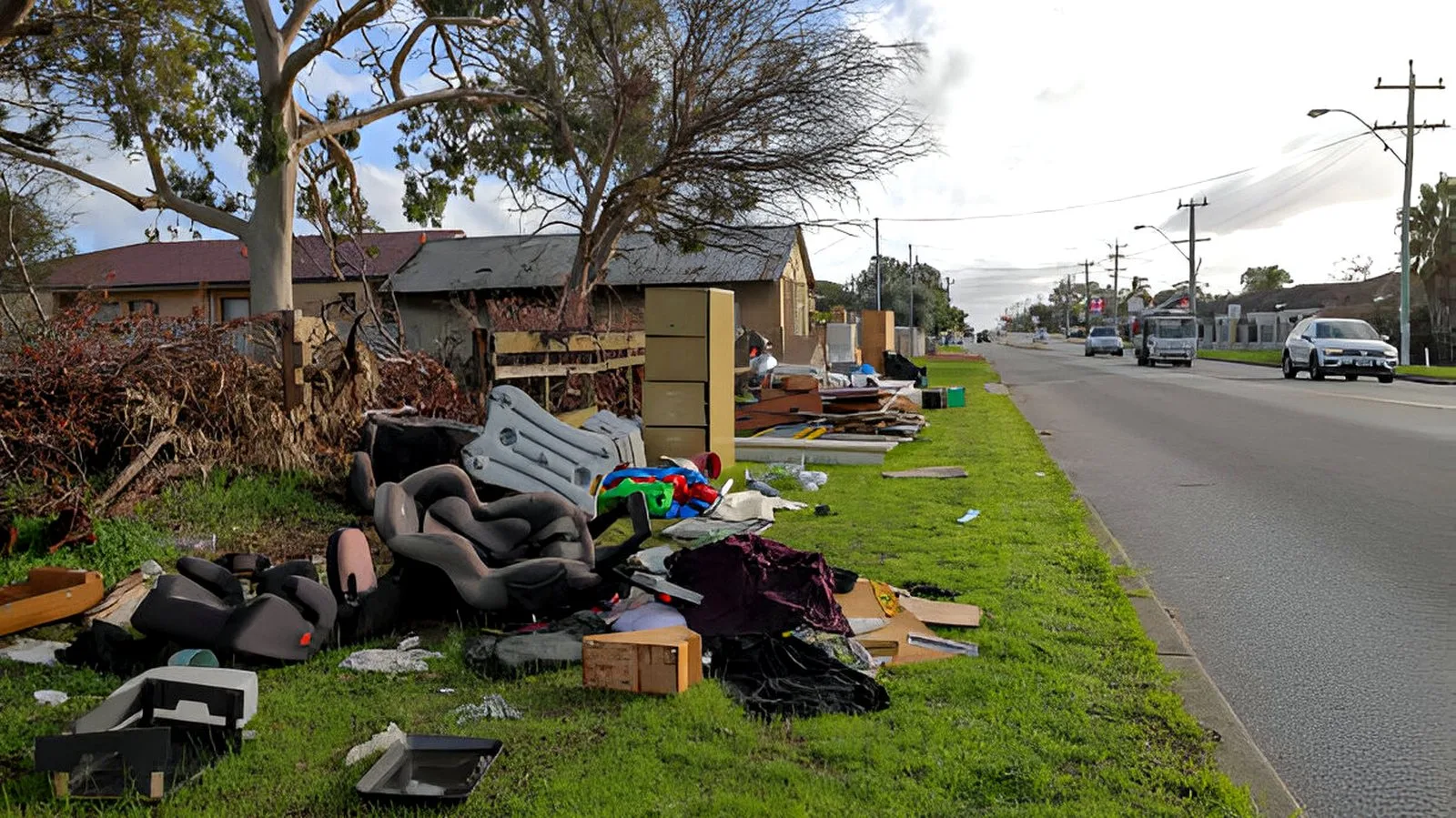 Curbside pile of old sofas and household junk cleared from a street