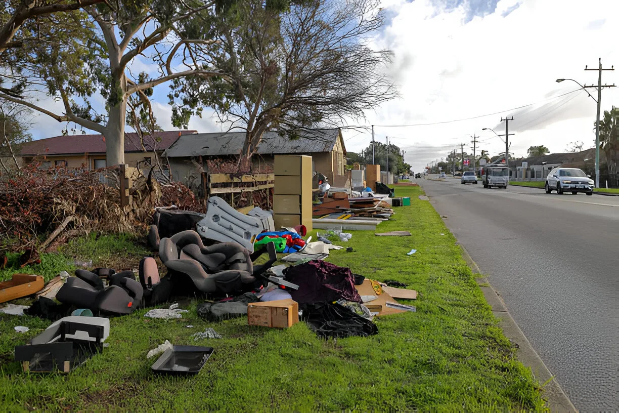 Whole-property cleanout with furniture and household junk cleared to the curb