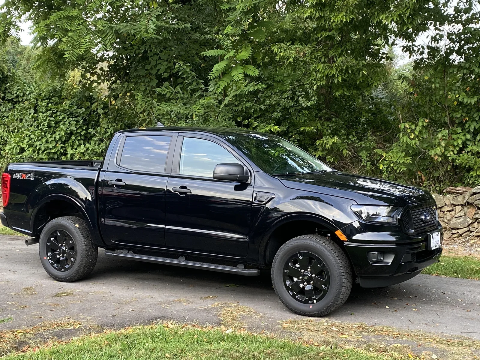 Buddies Junk Removal branded black truck parked and ready on a job